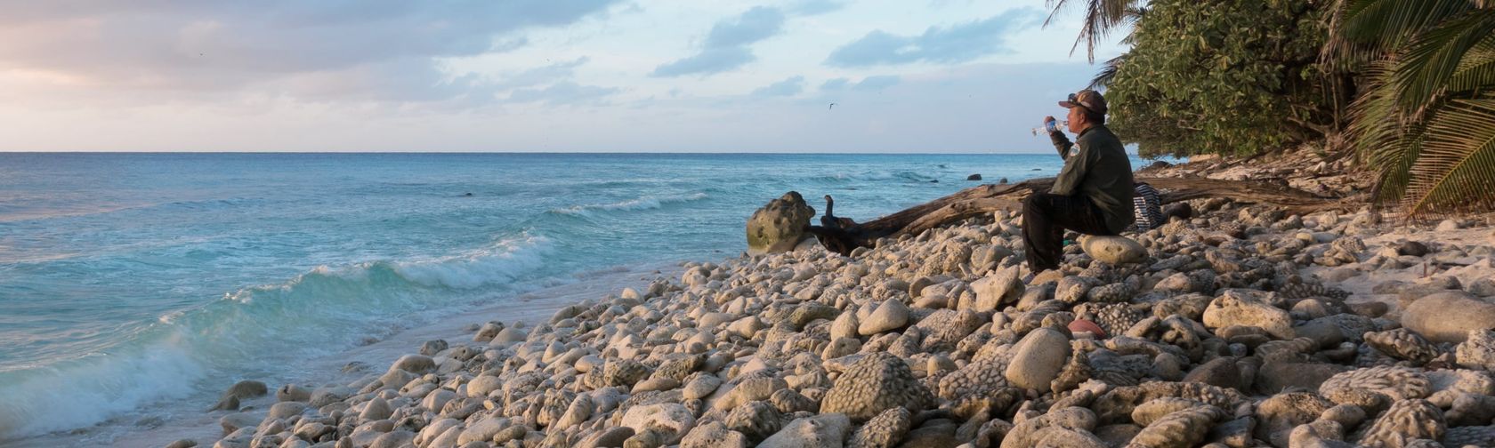 Park ranger on a coral shingle beach. Photo: Rik Soderlund